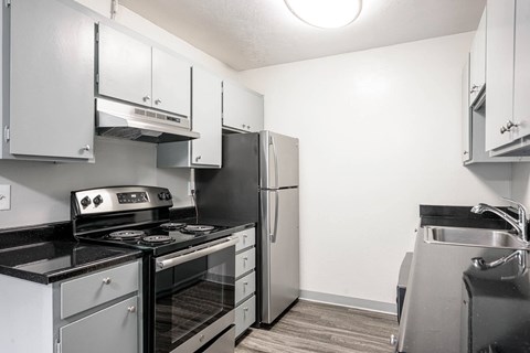 A kitchen with a stove, oven, and refrigerator.