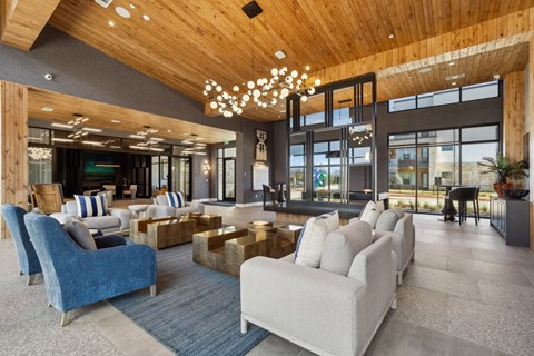 A modern living room with a wooden ceiling and a large window.