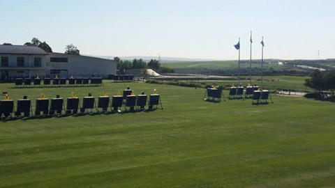 a row of chairs on a grass field