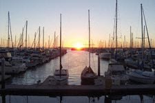 a harbor filled with boats at sunset
