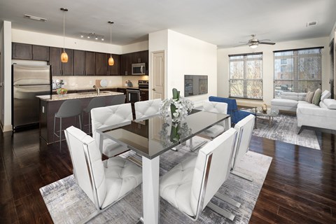 a living room and dining room with white chairs and a glass table