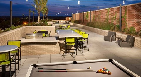 A pool table is set up on a rooftop patio.