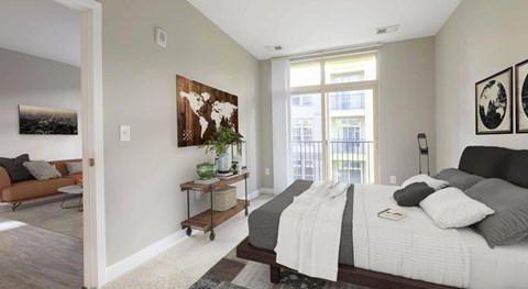 A bedroom with a large bed and a painting on the wall.
