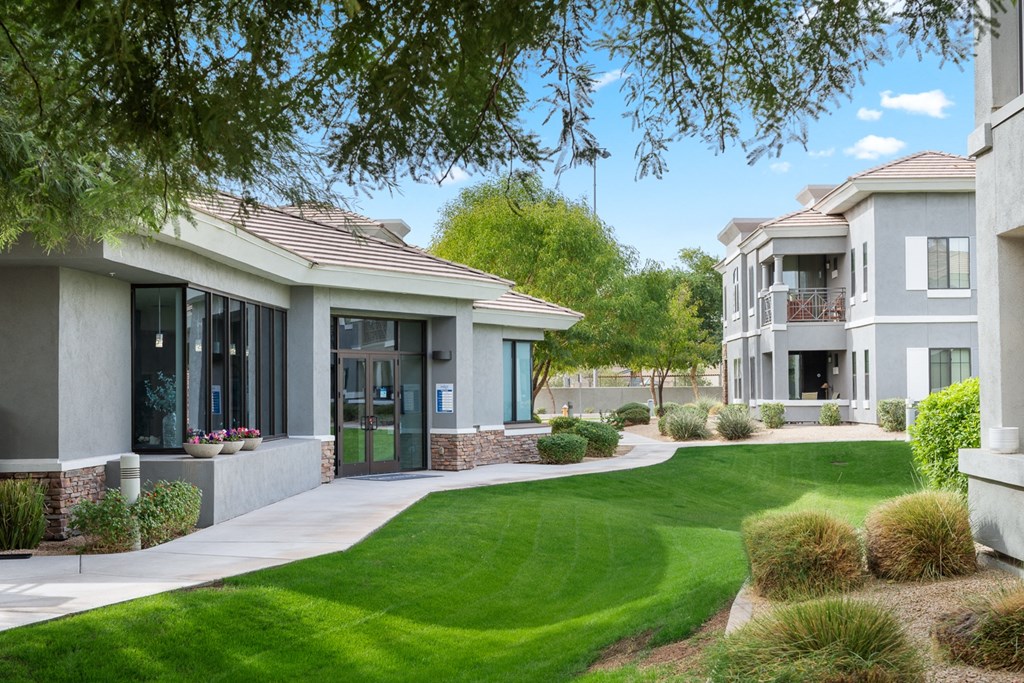 a home with a green lawn and a sidewalk