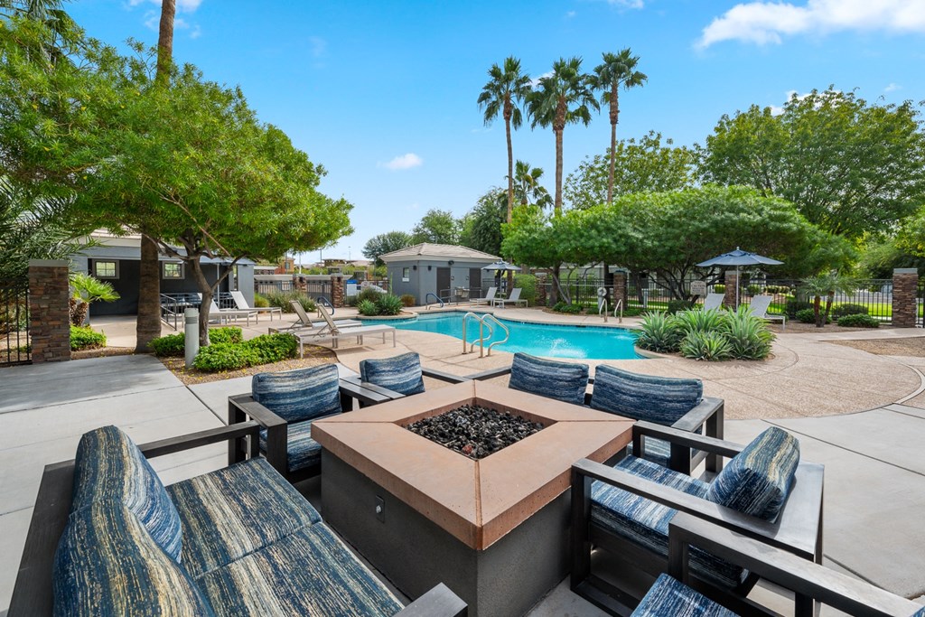 a patio with a table and chairs and a swimming pool