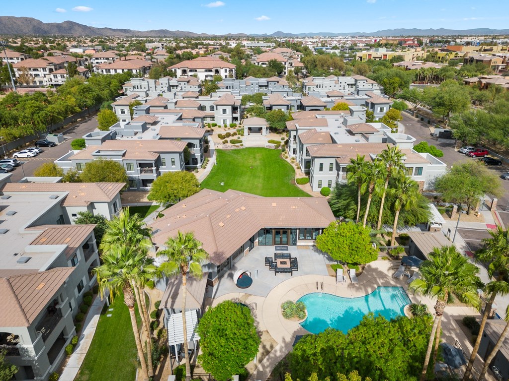 an aerial view of a neighborhood with houses and a pool