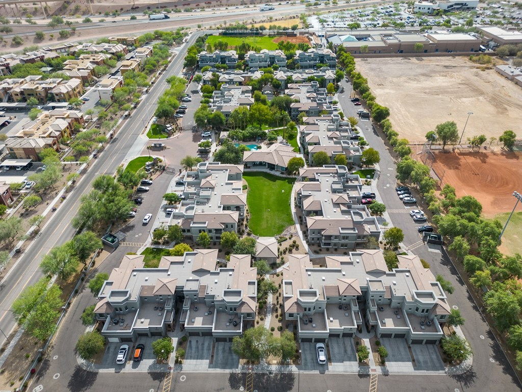 an aerial view of a neighborhood of houses in a suburban area with cars parked in