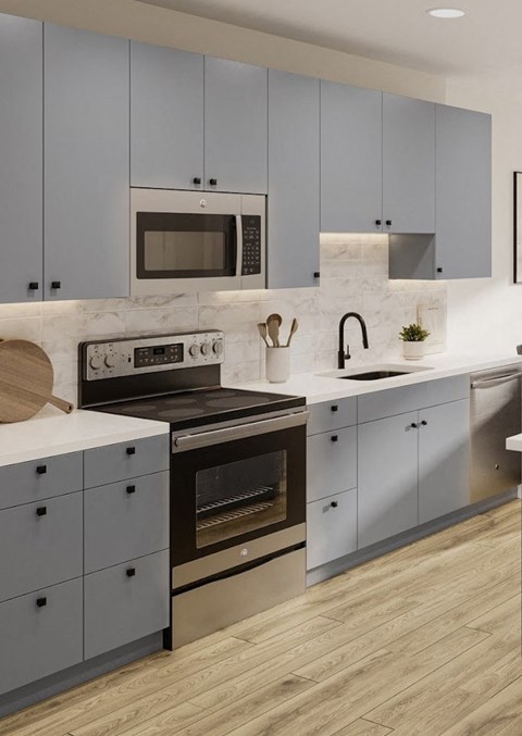 a kitchen with stainless steel appliances and white cabinets