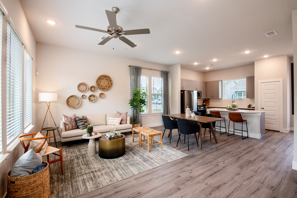 a living room with a couch and a table and a kitchen