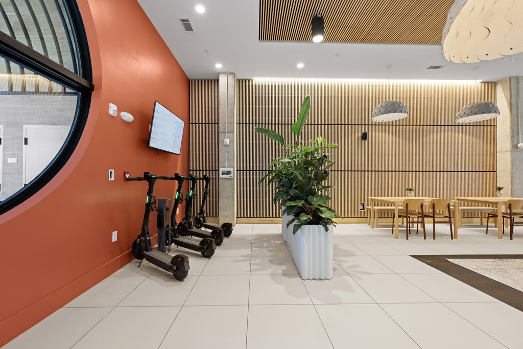 A white planter sits in the middle of a room with orange walls.