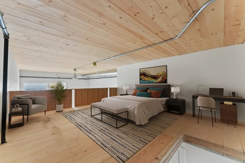 A bedroom with a bed, desk, and chair.