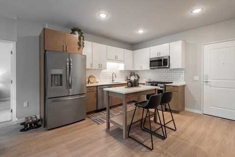 A kitchen with a table and chairs.