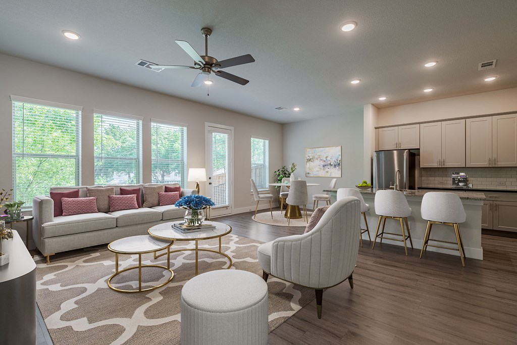 an open living room and kitchen with a ceiling fan