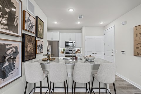 A modern kitchen with a dining table set for four.