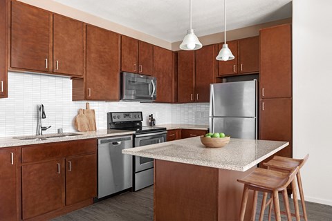 a kitchen with stainless steel appliances and wooden cabinets