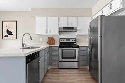 a kitchen with stainless steel appliances and white cabinets
