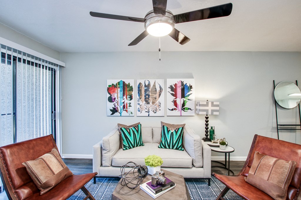 a living room with a ceiling fan and a sliding glass doorat The Julia, Mesa
