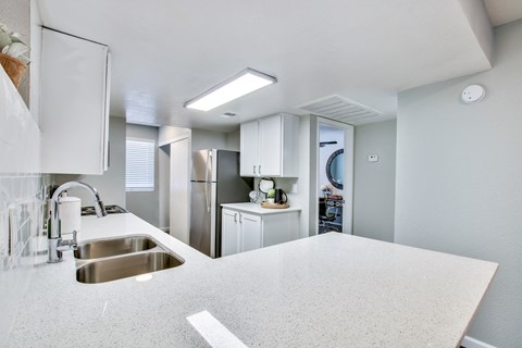 a kitchen with white cabinets and a white counter topat The Julia, Arizona, 85210
