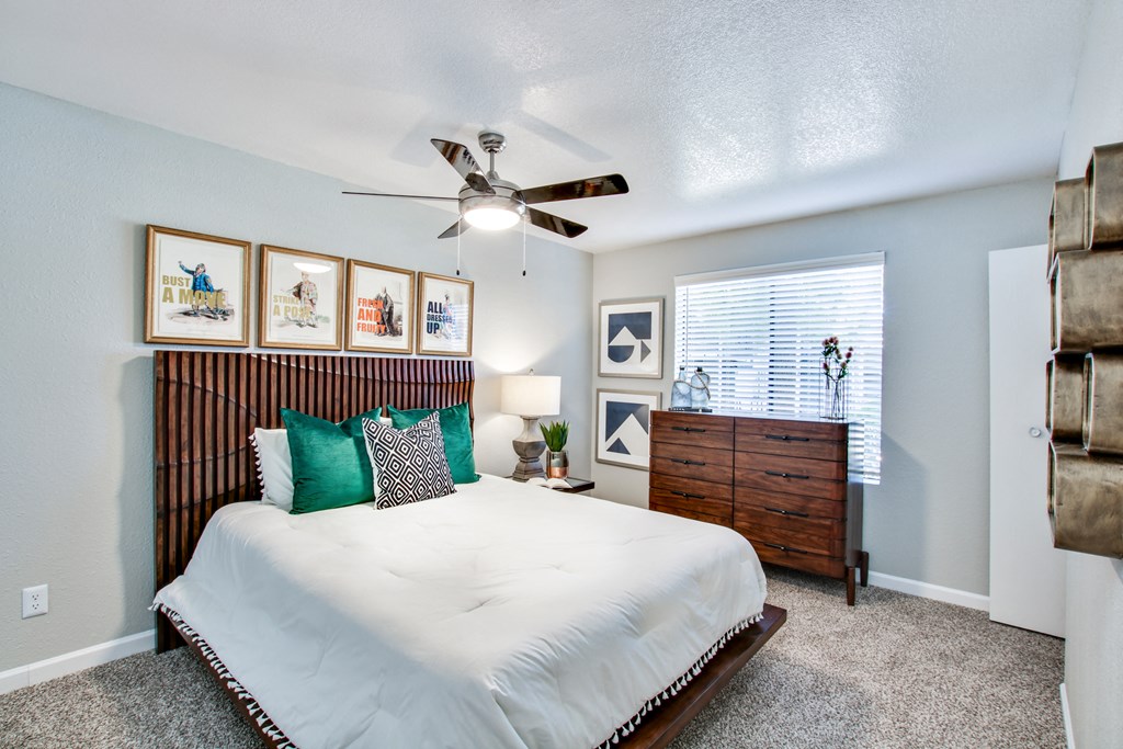 a bedroom with a large bed and a ceiling fanat The Julia, Mesa, AZ