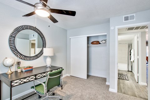 a bedroom with a desk and a ceiling fanat The Julia, Mesa