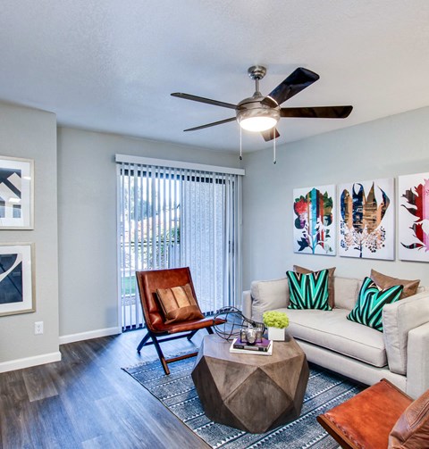 a living room with a couch chair coffee table and ceiling fanat The Julia, Mesa, AZ