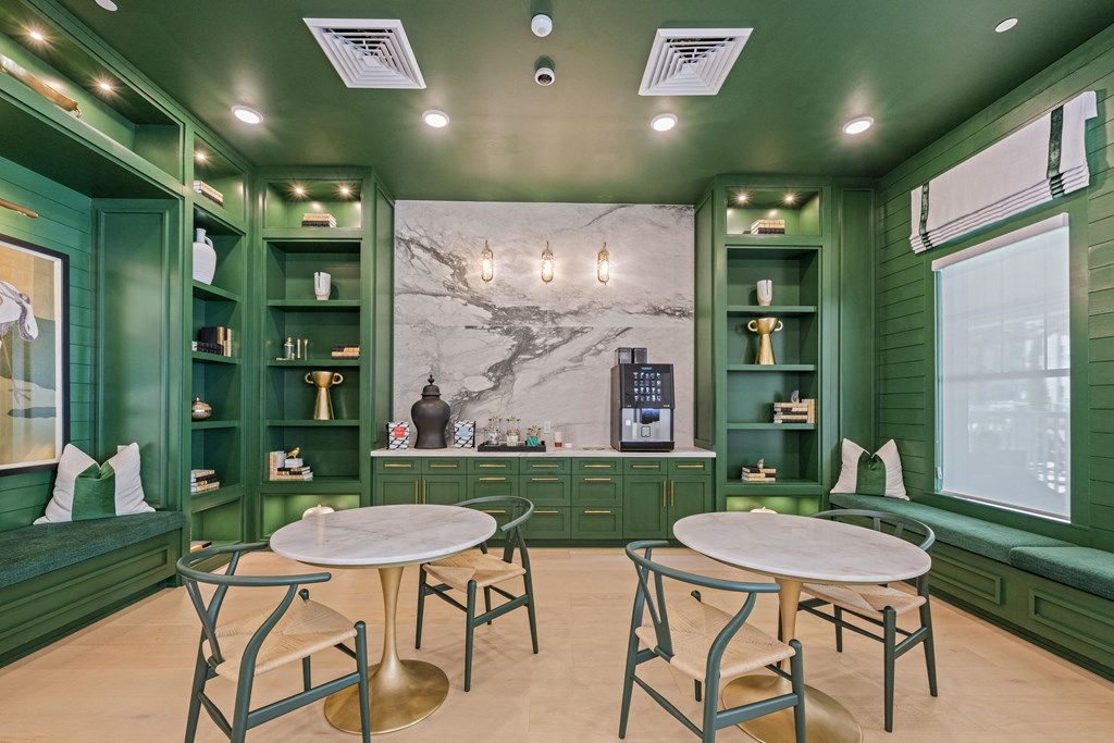 a tasting room with two tables and chairs and green shelves