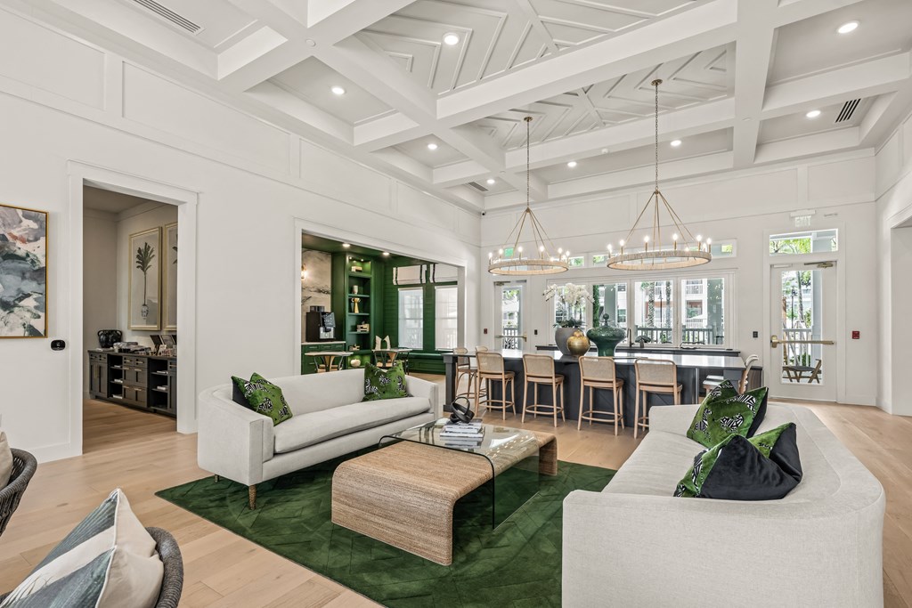 the living room has a coffered ceiling and a dining room with a large table