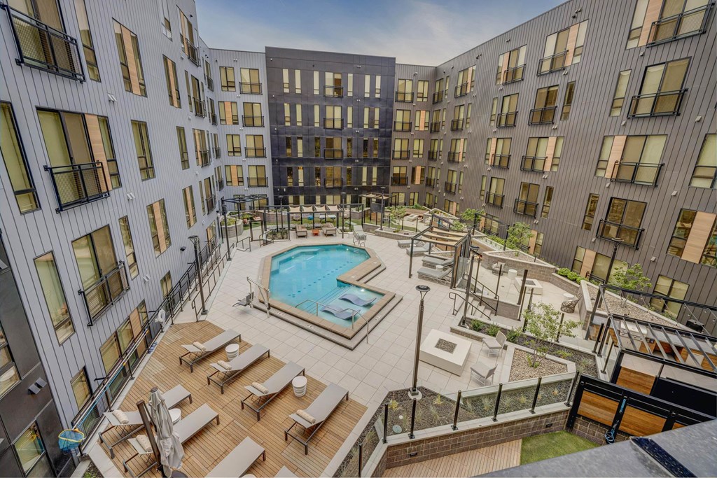 Aerial view of a resort-style pool with lounge areas at Luma new Salt Lake City apartments.