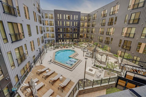 Aerial view of a resort-style pool with lounge areas at Luma apartments for rent in Salt Lake City, Utah.