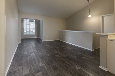 A room with wooden flooring and a window.