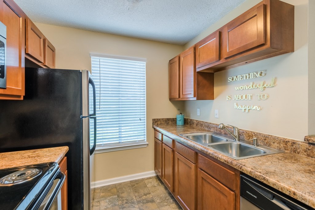 a kitchen with a sink and a refrigerator