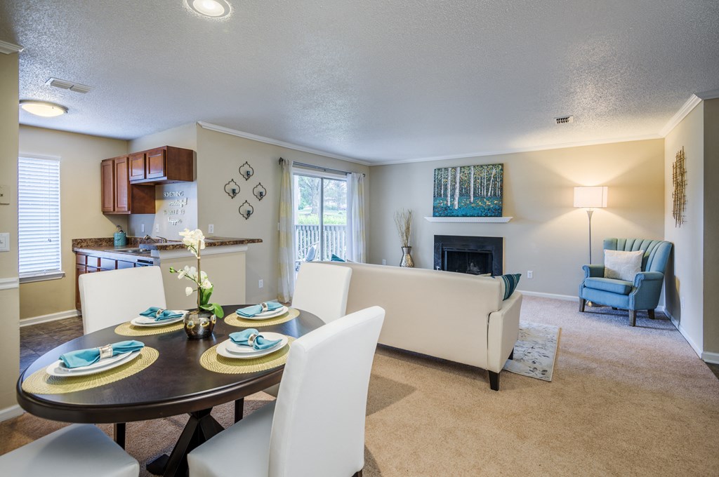 a living room and dining room with a table and chairs