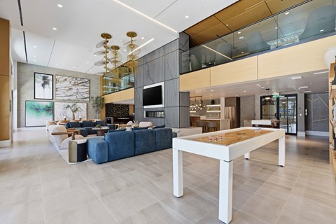A modern living room with a blue sofa and a wooden coffee table.