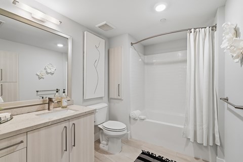 A white bathroom with a toilet, sink, and bathtub.