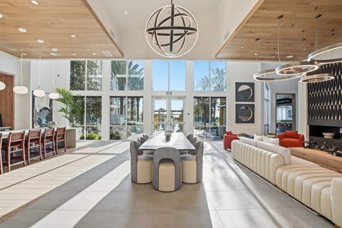 A modern living room with a large table and chairs.