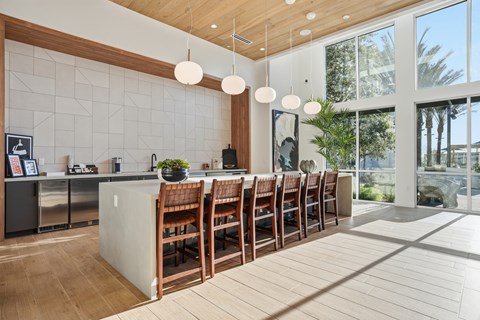 A kitchen with a long wooden table and chairs.