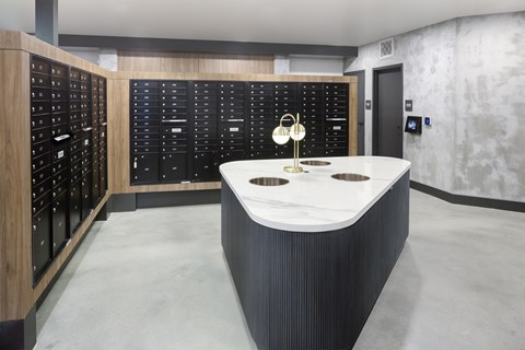 A modern kitchen with a marble countertop and a black cabinet with white handles.