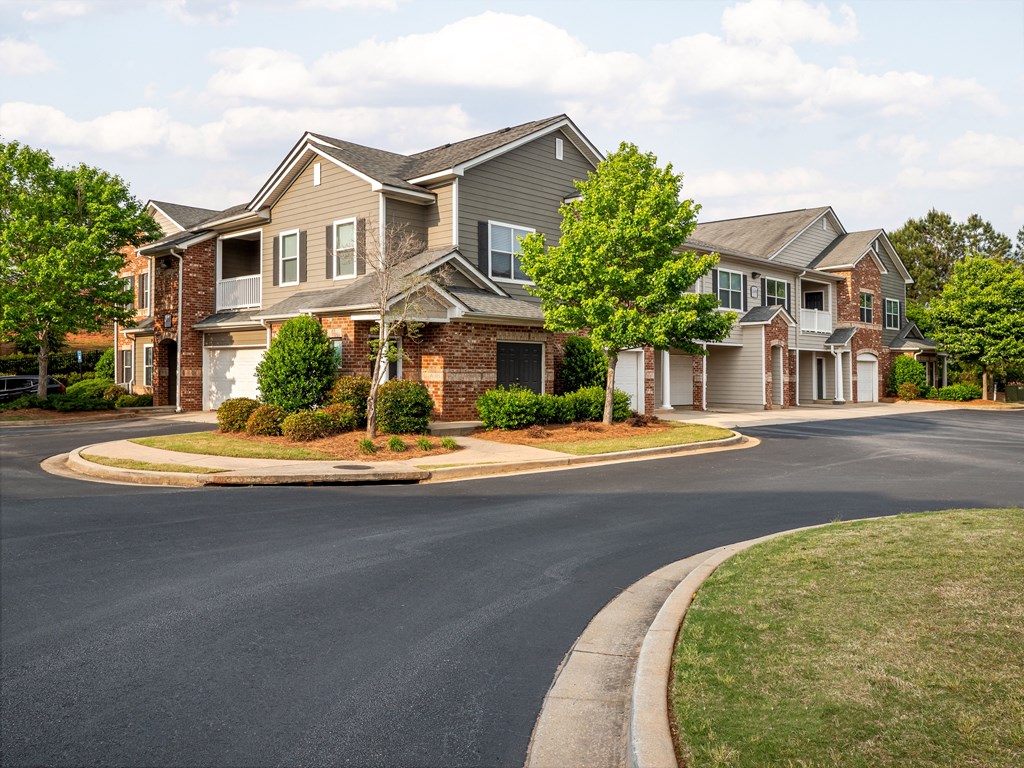 an empty street in front of a large house