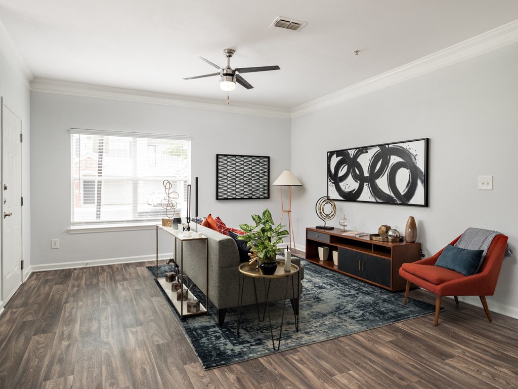 a living room with a couch and a chair and a table