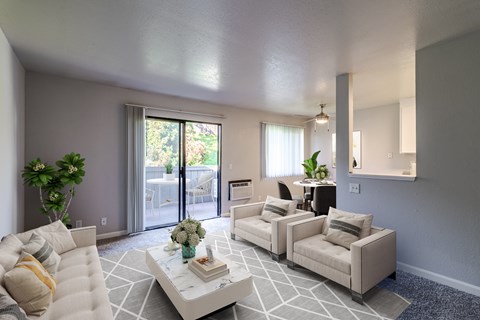 A living room with a white couch and a coffee table.