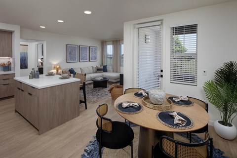 A modern dining room with a round table set for four.