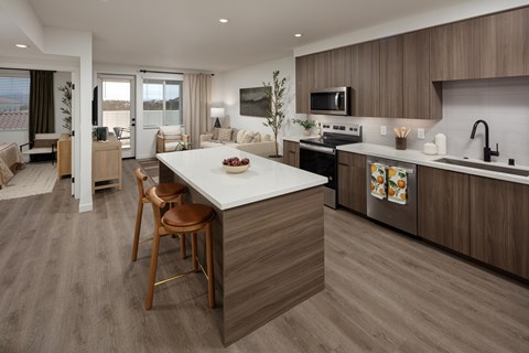 A modern kitchen with a dining table and chairs.