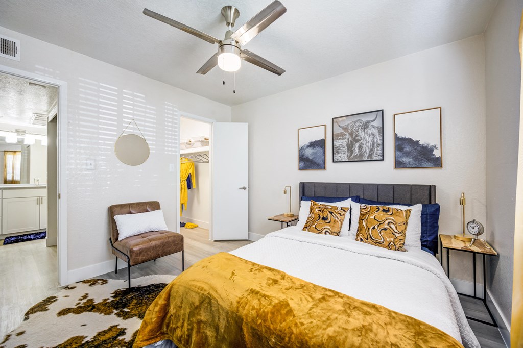 a bedroom with a bed and a ceiling fan