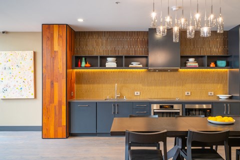 a kitchen with blue cabinets and a table and chairs