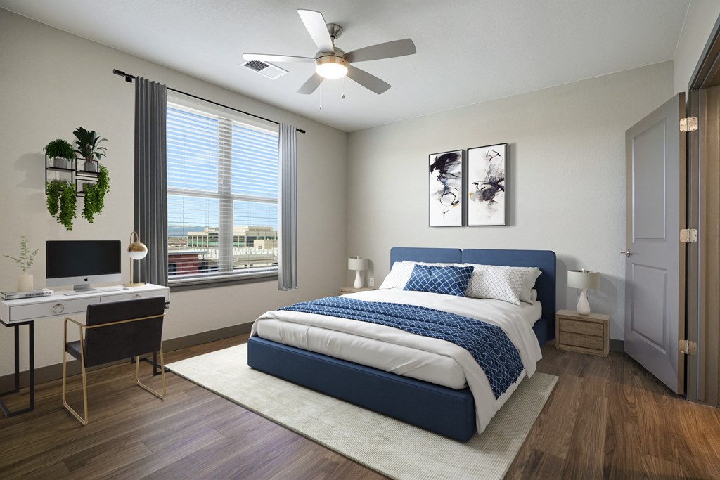 Virtually staged bedroom with wood style flooring and ceiling fan  at Novus, Lone Tree