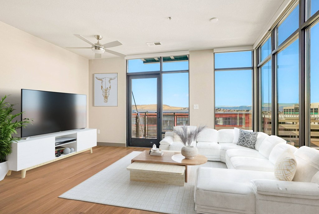 Virtually staged living room with corner floor to ceiling windows, patio and wood style flooring  at Novus, Colorado, 80124