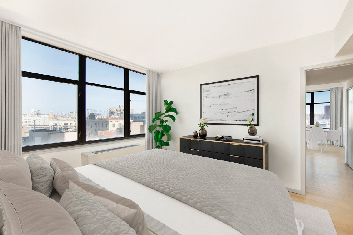 A bedroom with a large bed and a view of the city.