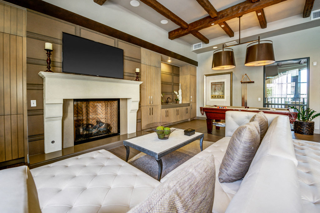 a living room with a fireplace and a television