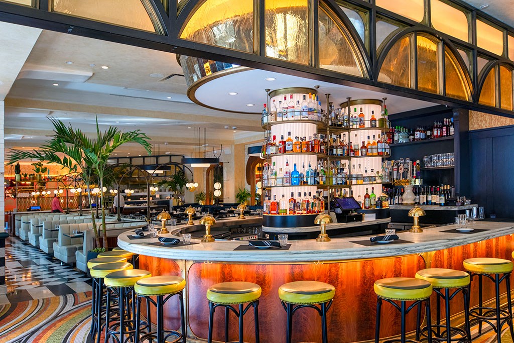 a bar with yellow stools at the front of a restaurant