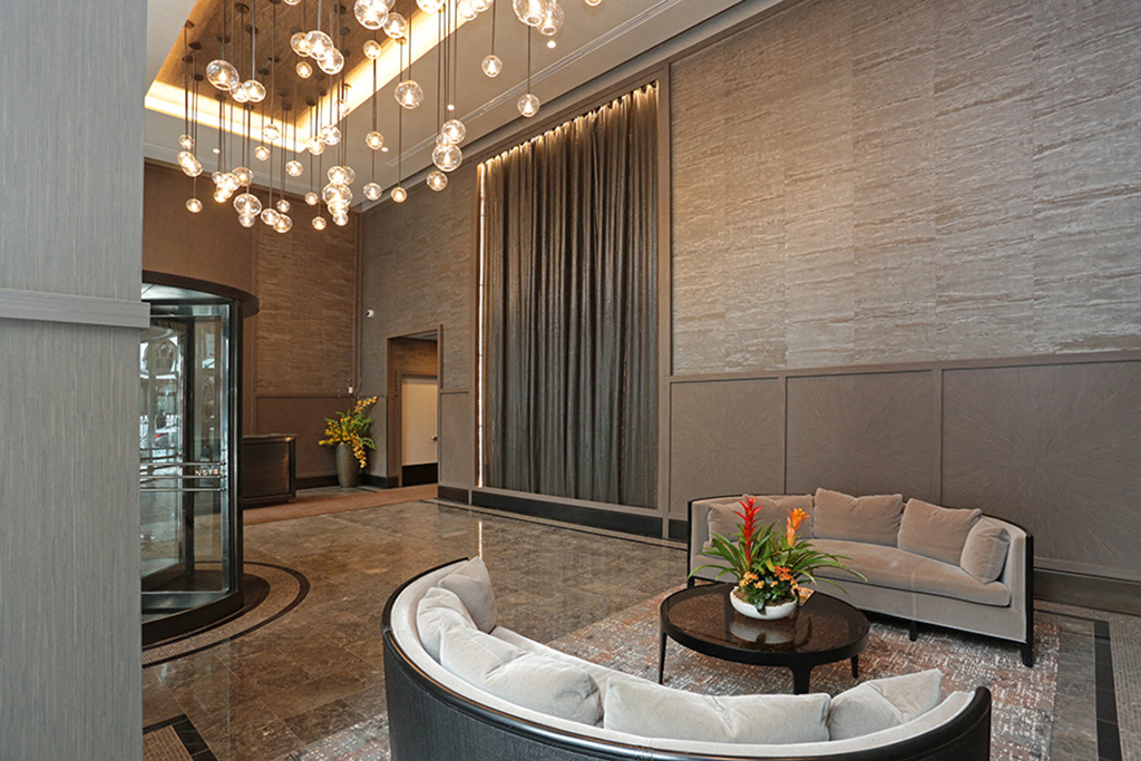 a living room with a couch and a table and a chandelier